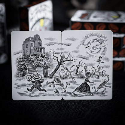 Halloween-themed playing cards with black and white illustrations on a dark background.