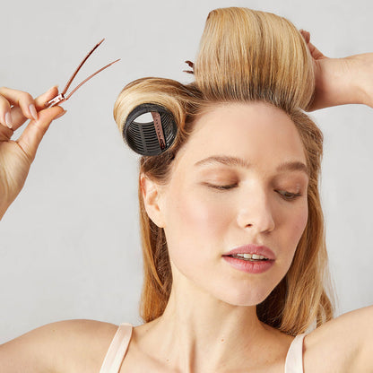 Kitsch Hair Rollers + Styling Clips Bundle lifestyle shot with model in soft pink setting