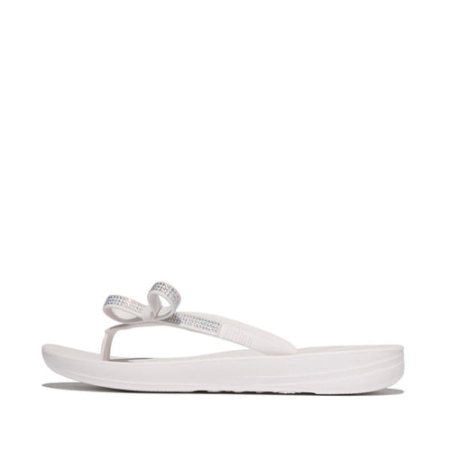 iQUSHION Glitz-Bow flip-flops with cushioned footbed, anatomically shaped straps, delicate bow detail, waterproof and lightweight.