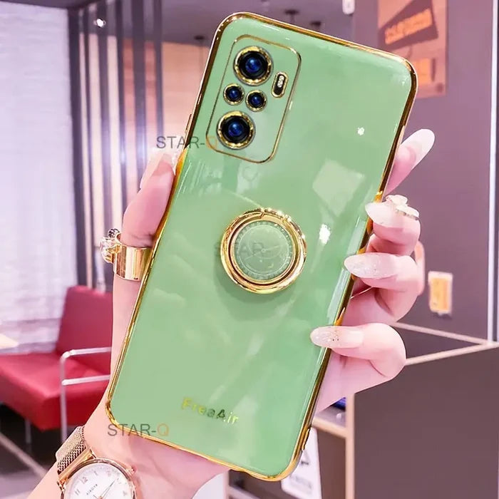 a woman holding a green phone case with a gold ring