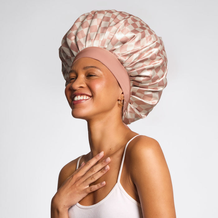 Model wearing KITSCH Terracotta Checker Oversized Satin Bonnet — lifestyle shot — worn while sleeping to protect hair overnight